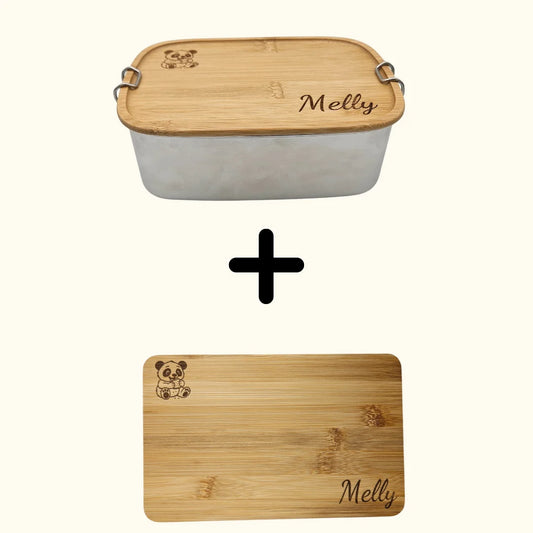 Personalisiertes Geschenkset bestehend aus einer Edelstahl-Brotdose mit Bambusdeckel und einem passenden Frühstücksbrettchen aus Bambus; beide Teile sind hochwertig mit einem Tiermotiv und einem Namen, hier beispielhaft „Melly“ graviert. Ein nachhaltiges Bundle für Schule, Kindergarten oder Ausflüge
