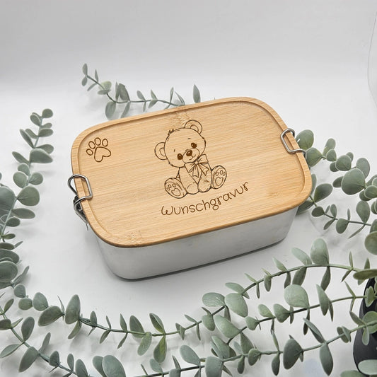 Personalisierte Brotdose mit einem Teddybär Motiv und eine Pfote oben links sowie mit einer Wunschgravur als Name oder Text